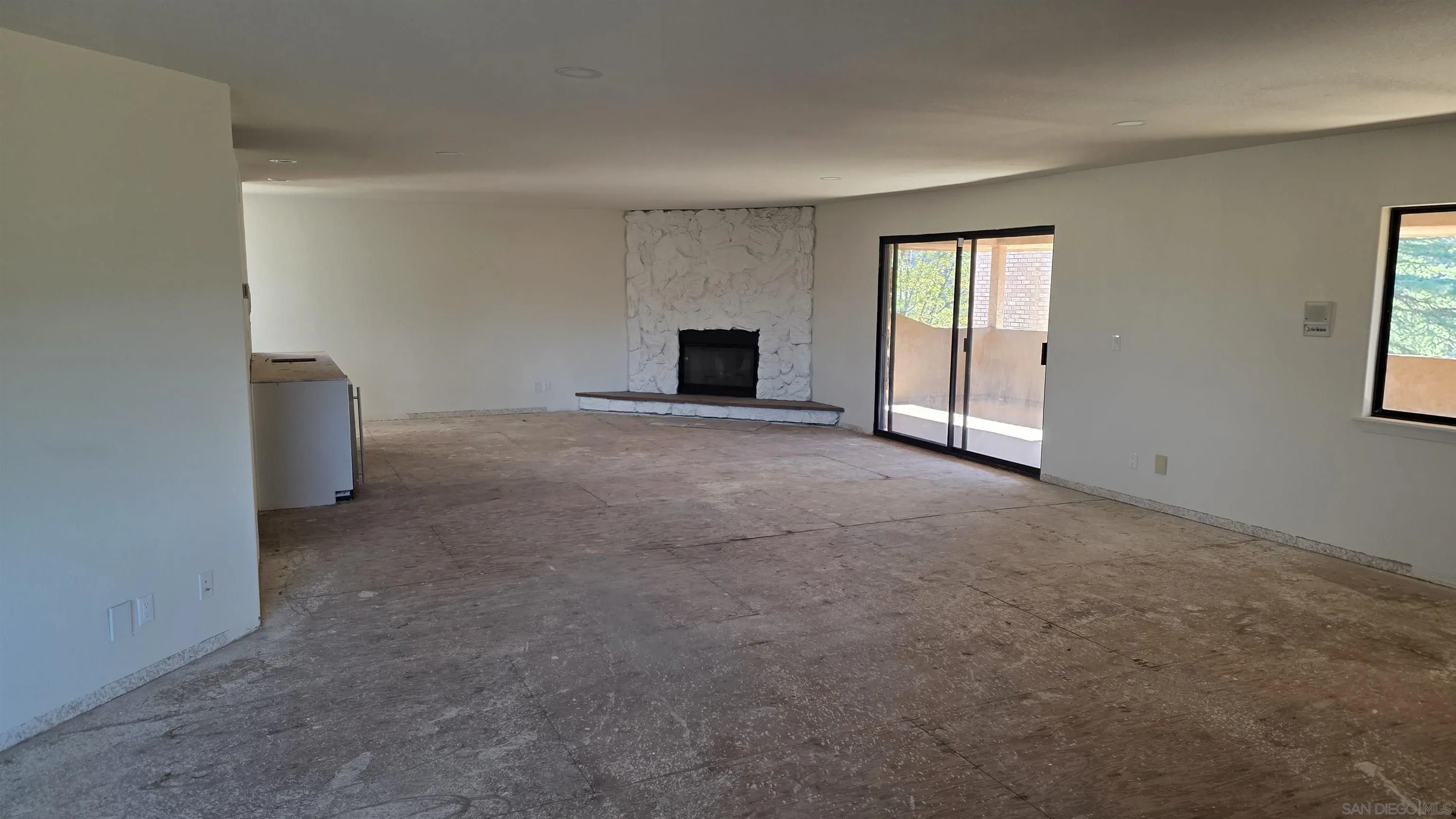 3725 Via Cielo Azul Alpine, CA 91901 - Photo 6 of 37 a view of an empty room with a fireplace and a window