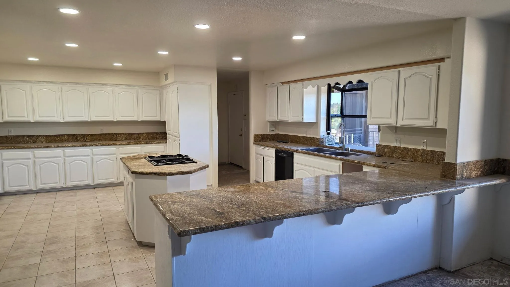 3725 Via Cielo Azul Alpine, CA 91901 - Photo 9 of 37 a kitchen with stainless steel appliances granite countertop a sink wooden cabinets and a granite counter tops