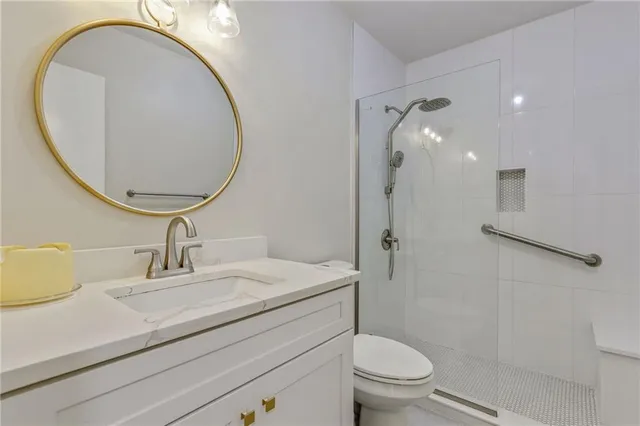 a bathroom with a sink a toilet and a mirror