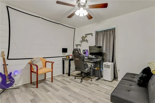 a view of a workspace with furniture and a window