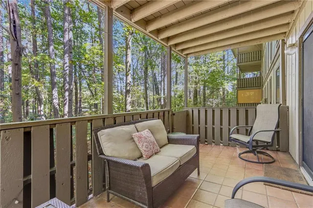 a balcony with furniture and a potted plant