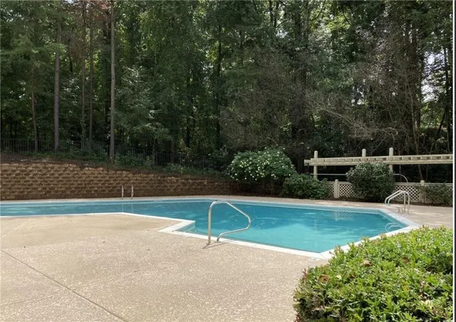 a view of backyard with swimming pool