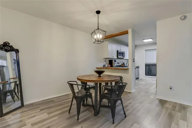 a view of a dining room with furniture wooden floor and a chandelier