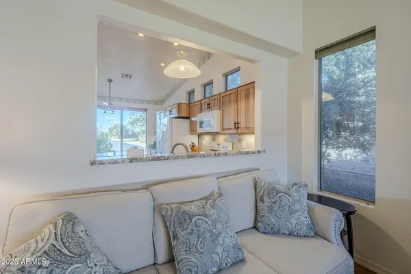 a kitchen with stainless steel appliances granite countertop a sink a stove and a microwave oven