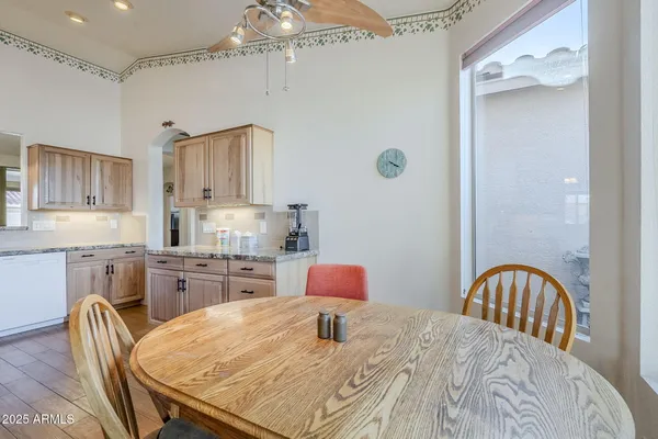 a kitchen with stainless steel appliances granite countertop a sink a stove cabinets and wooden floor