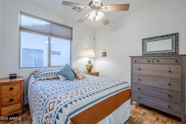 a bedroom with a bed and a lamp