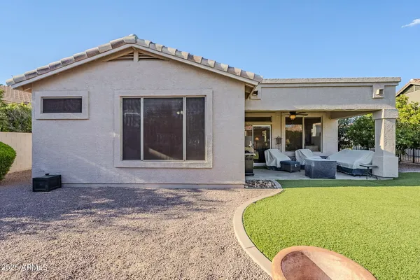 a view of a house with backyard and a garden