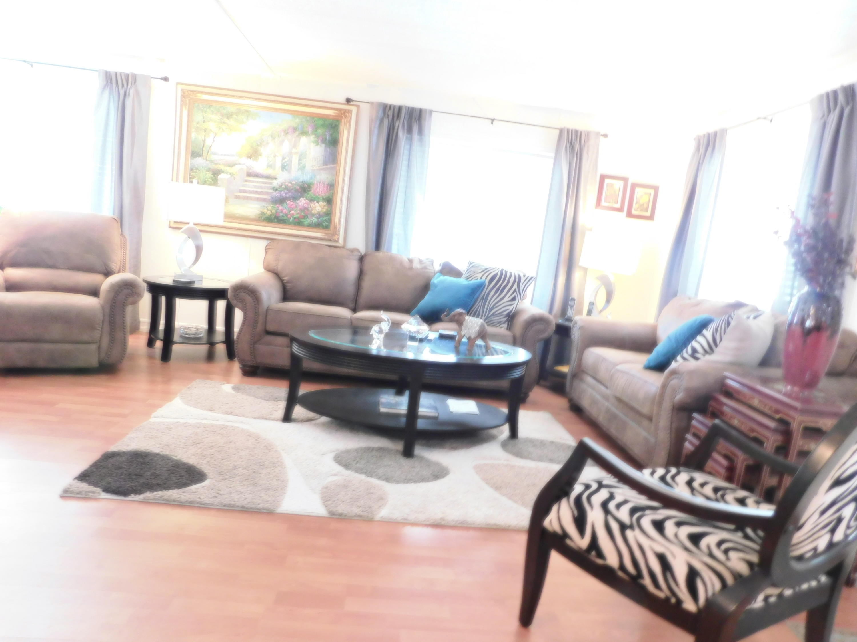 51555 Monroe Street, Unit 52 Indio, CA 92201 - Photo 2 of 42 a living room with furniture and a large window