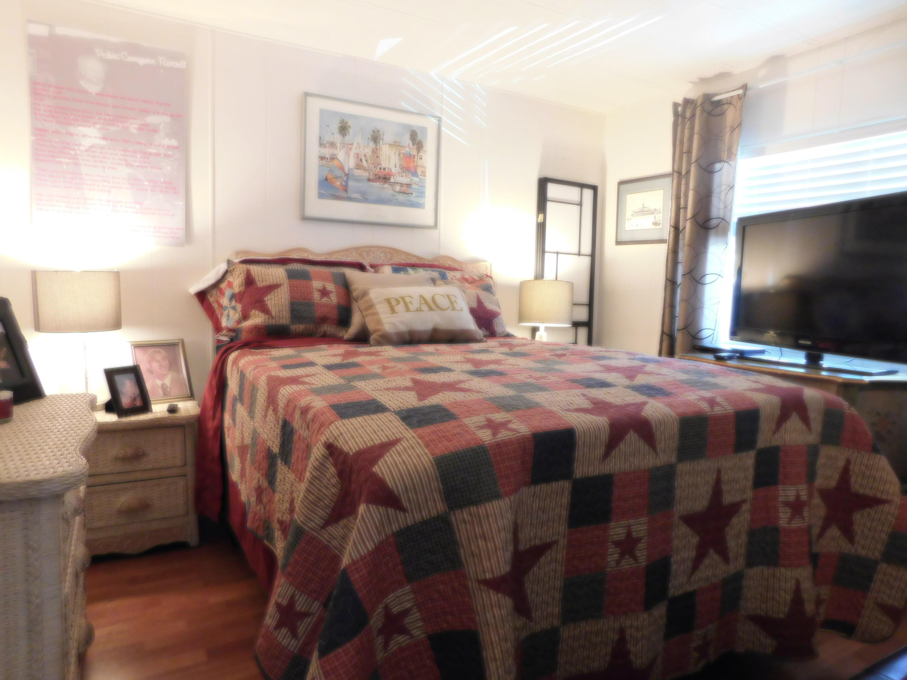 51555 Monroe Street, Unit 52 Indio, CA 92201 - Photo 15 of 42 a bedroom with a bed and a flat tv screen on dresser