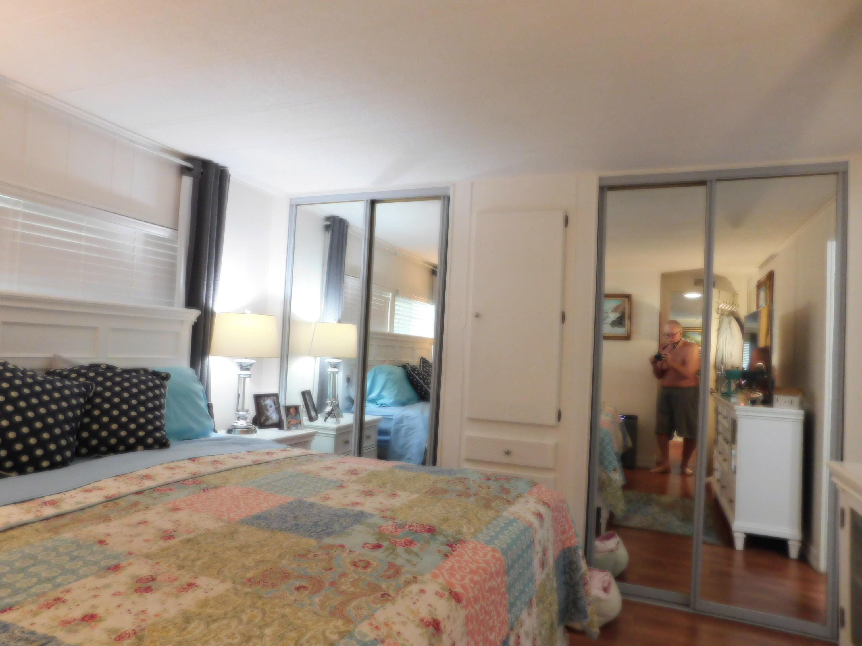 51555 Monroe Street, Unit 52 Indio, CA 92201 - Photo 21 of 42 a bedroom with a bed and a walk in closet