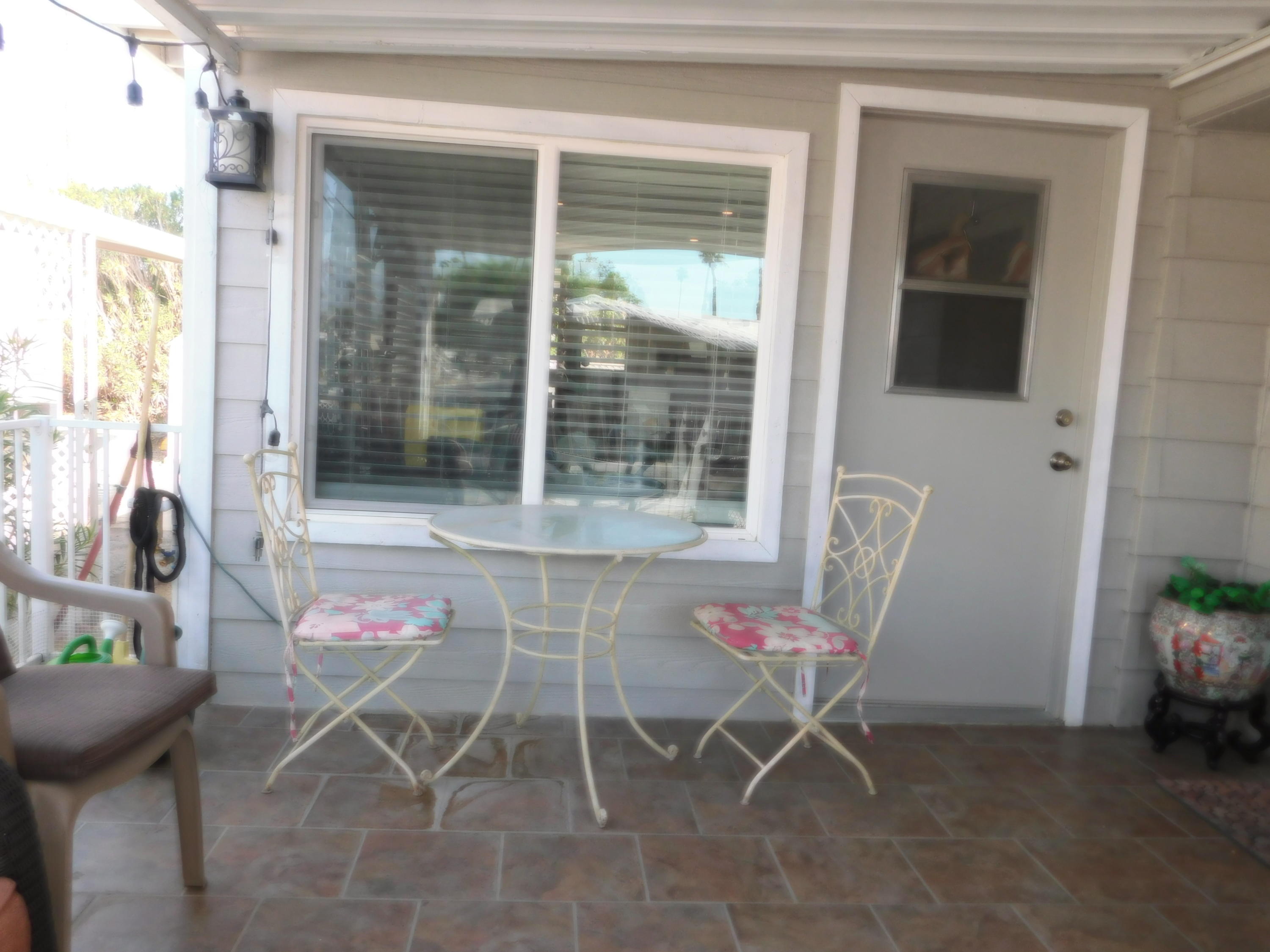 51555 Monroe Street, Unit 52 Indio, CA 92201 - Photo 27 of 42 a dining room with furniture and a potted plant