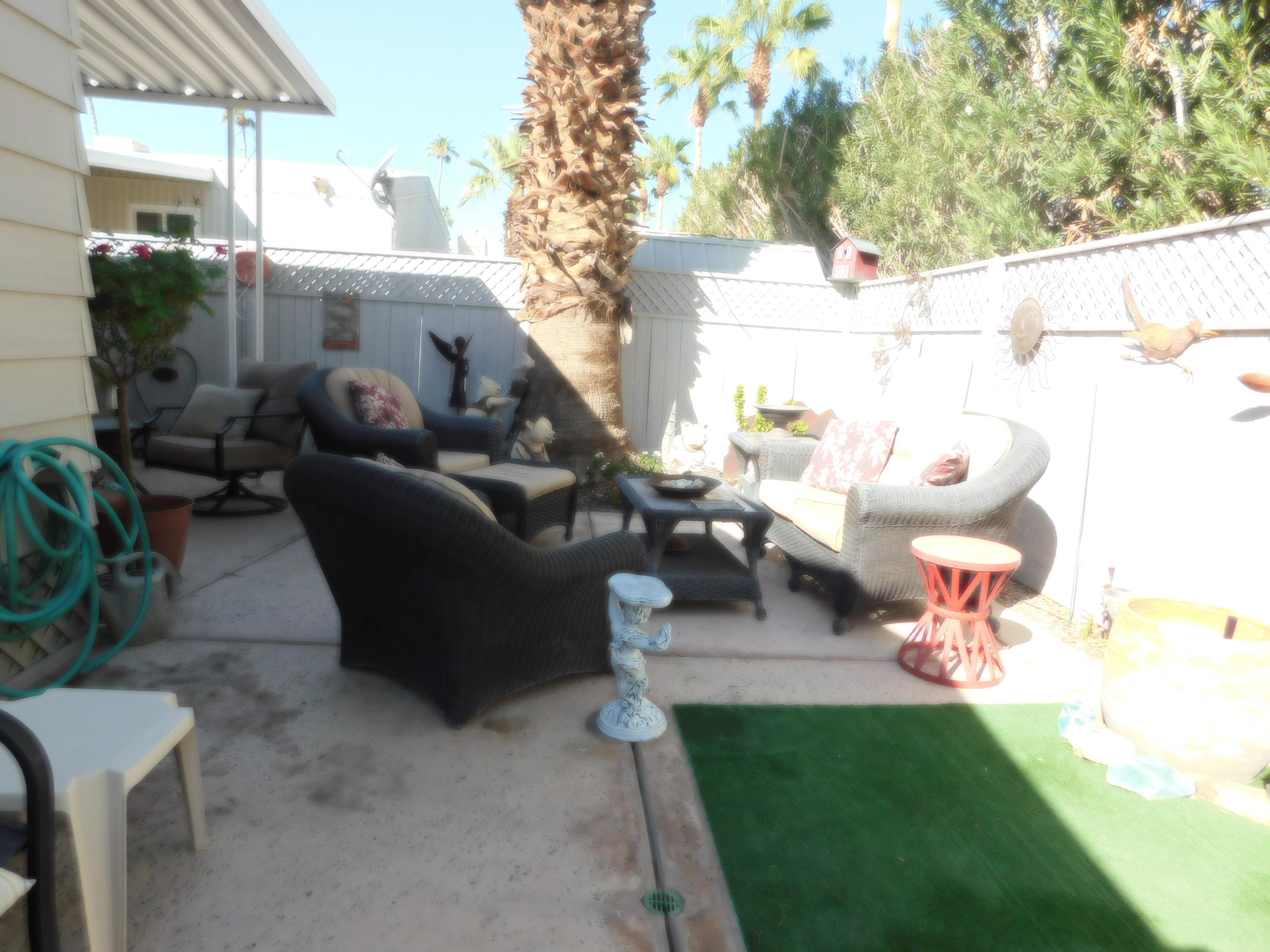 51555 Monroe Street, Unit 52 Indio, CA 92201 - Photo 30 of 42 a living room with patio furniture and a garden