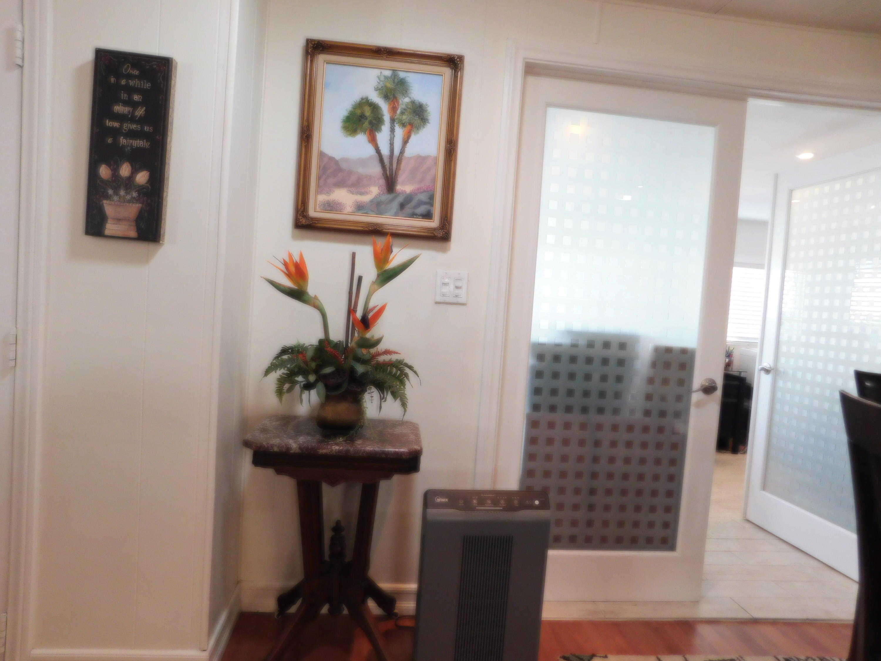 51555 Monroe Street, Unit 52 Indio, CA 92201 - Photo 6 of 42 a view of a hallway with furniture and a potted plant
