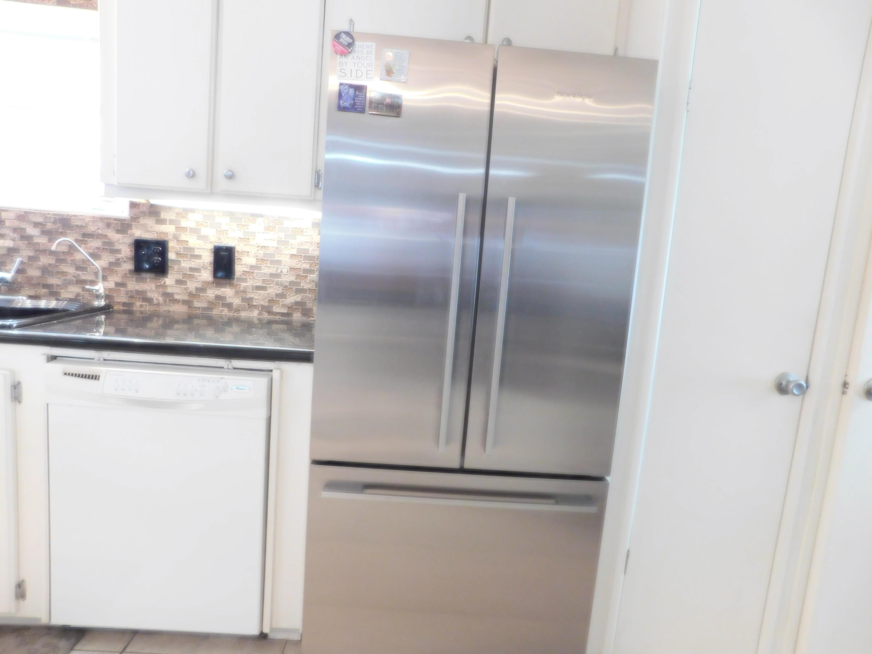 51555 Monroe Street, Unit 52 Indio, CA 92201 - Photo 9 of 42 a kitchen with a refrigerator and cabinets