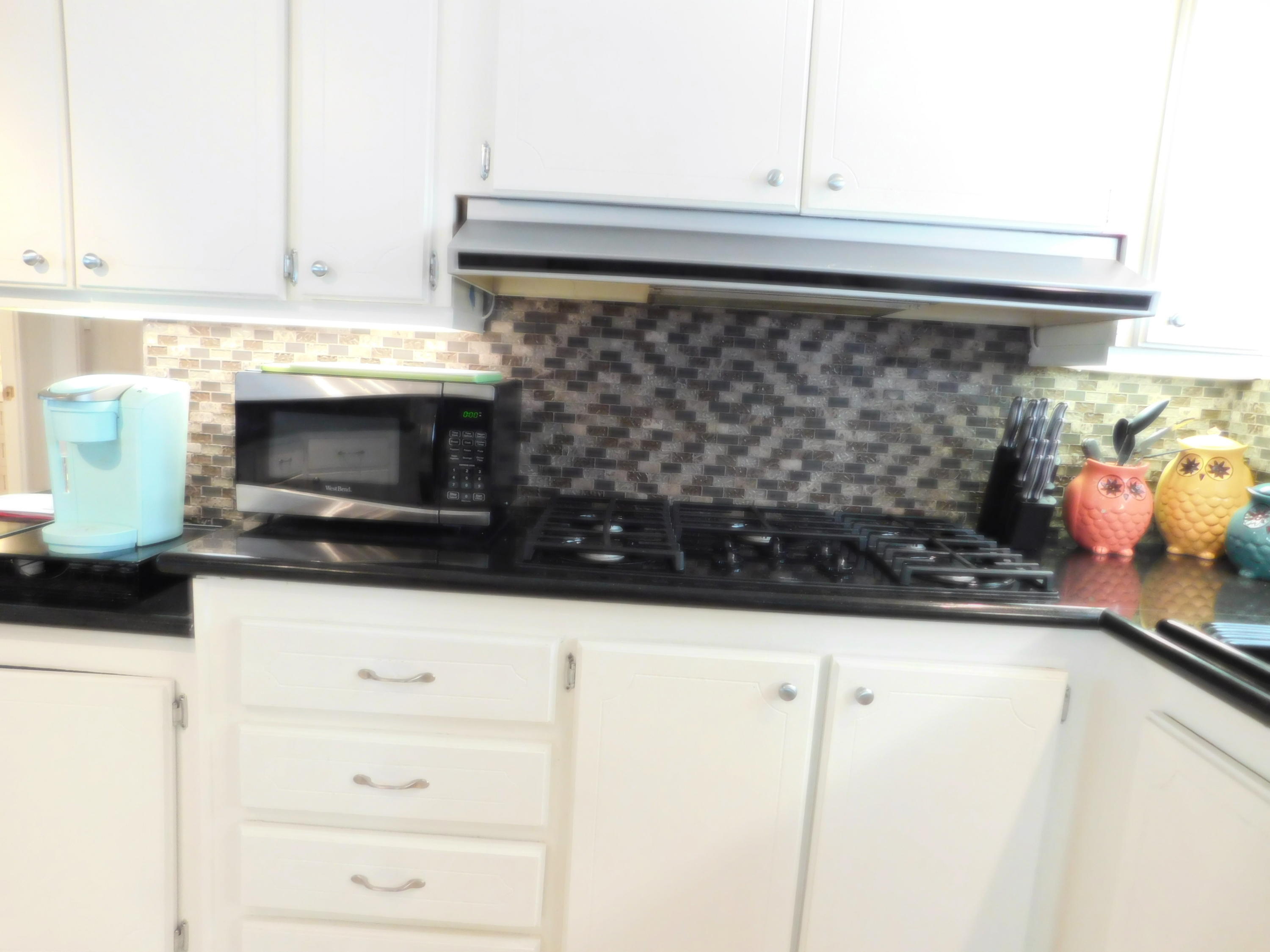 51555 Monroe Street, Unit 52 Indio, CA 92201 - Photo 10 of 42 a kitchen with a stove and a microwave