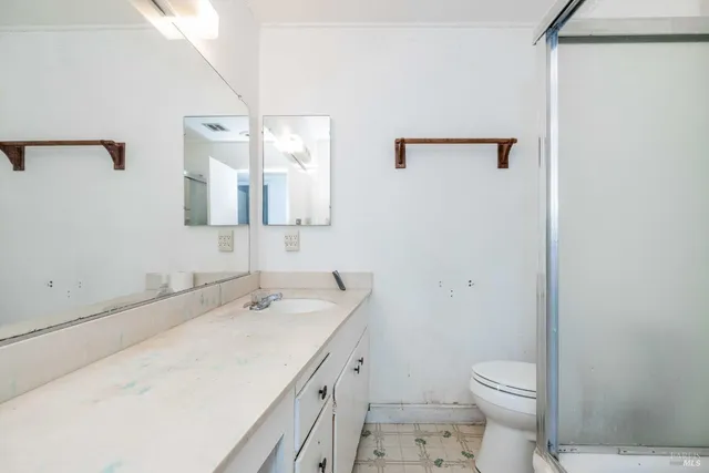 a bathroom with a sink a toilet and a mirror