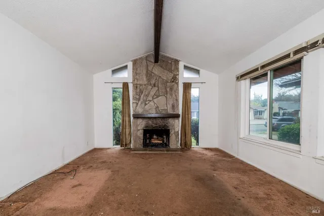 a view of empty room with fireplace