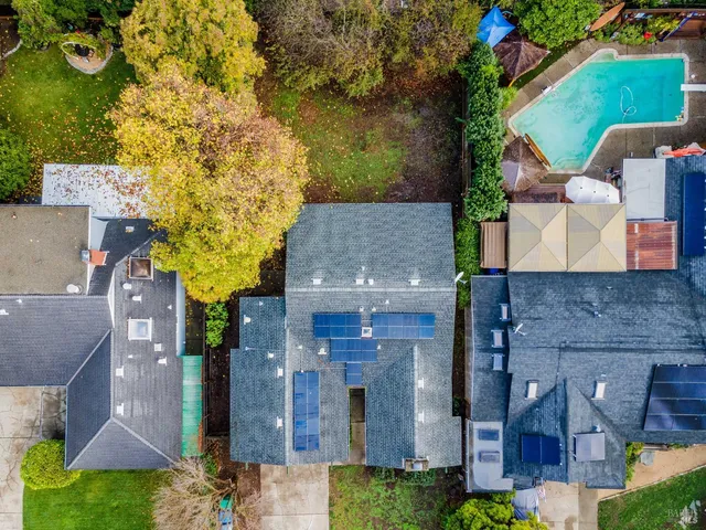 an aerial view of a house with garden space and a sitting area