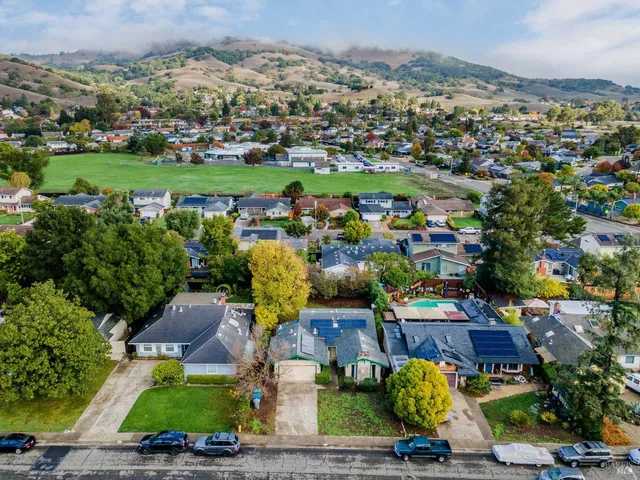 an aerial view of a house with a garden and lake view