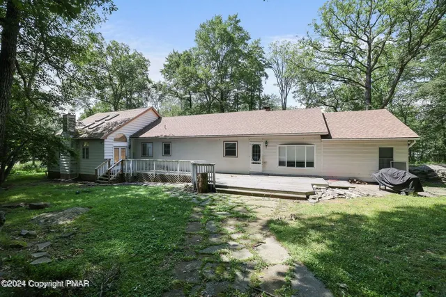 a view of a house with a yard porch and sitting area