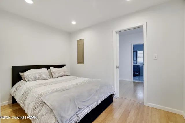 a bedroom with a bed and a mirror