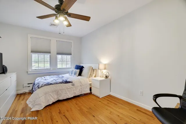 a bedroom with a bed and window