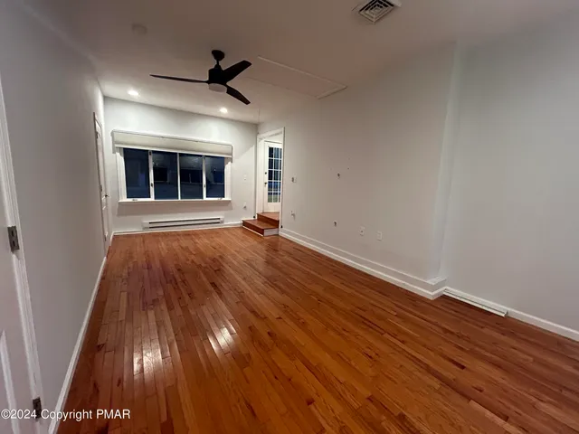 wooden floor in an empty room with a fireplace
