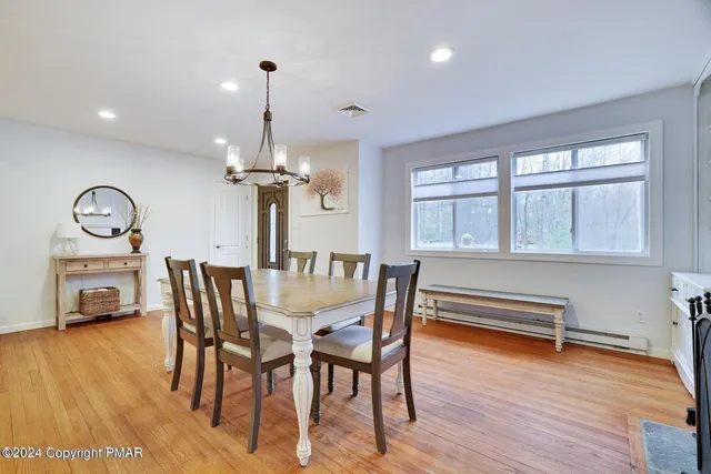 a view of a dining room with furniture window and wooden floor