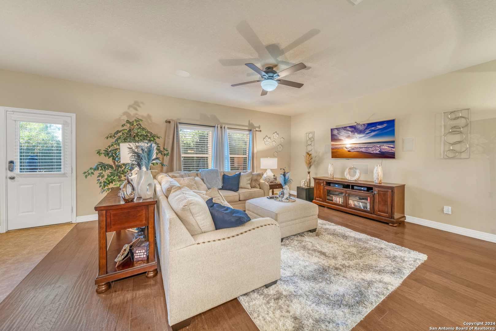 a living room with furniture and a wooden floor