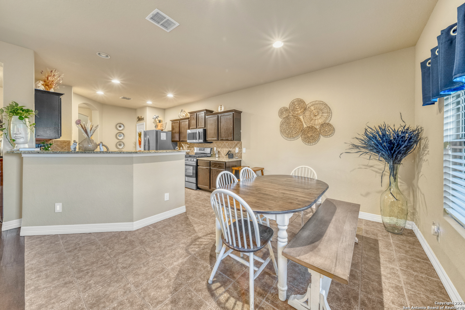 511 Fort Apache San Antonio, TX 78245 - Photo 13 of 32 a dining room with furniture and a kitchen view