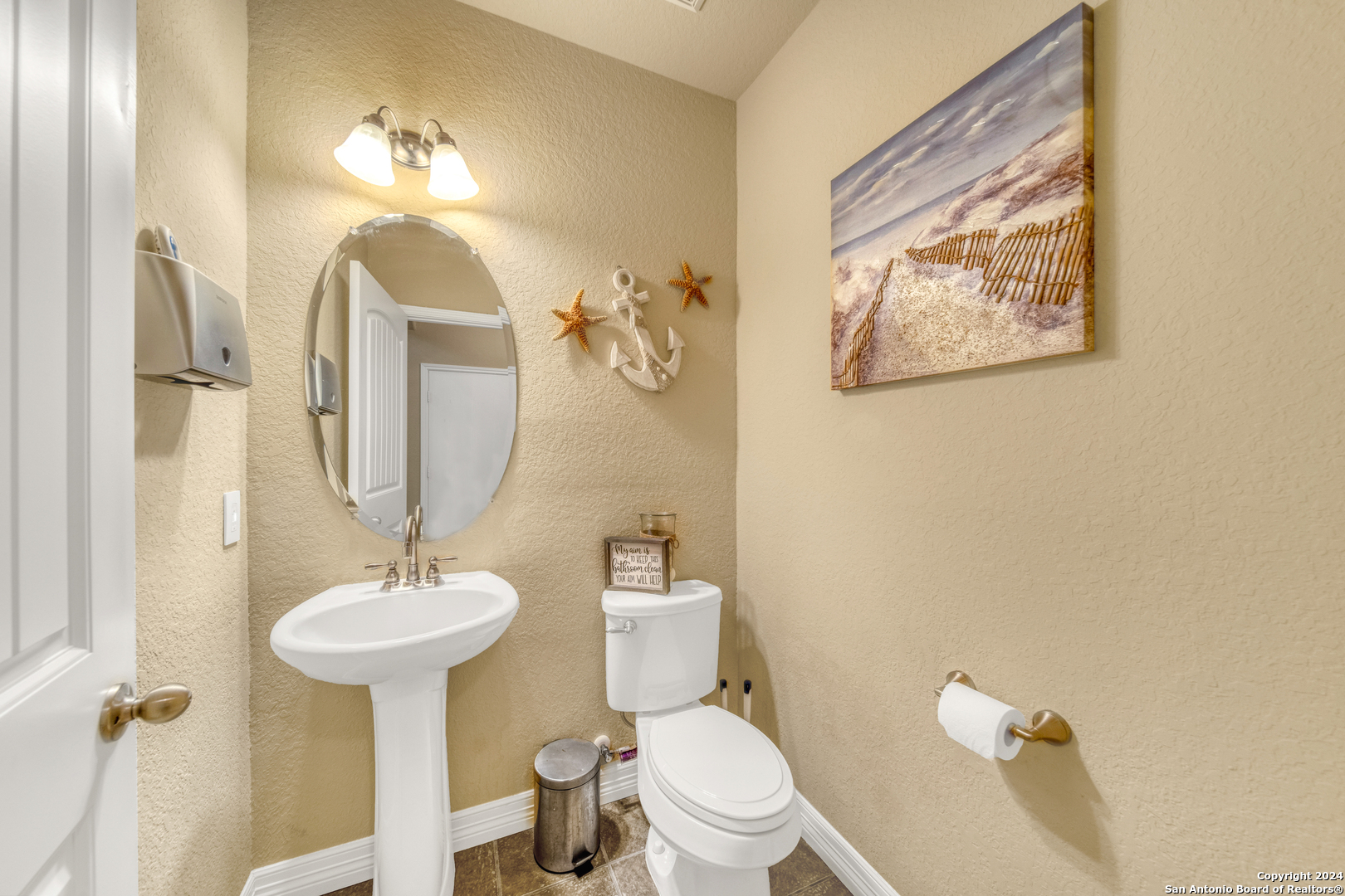511 Fort Apache San Antonio, TX 78245 - Photo 14 of 32 a bathroom with a toilet sink and mirror