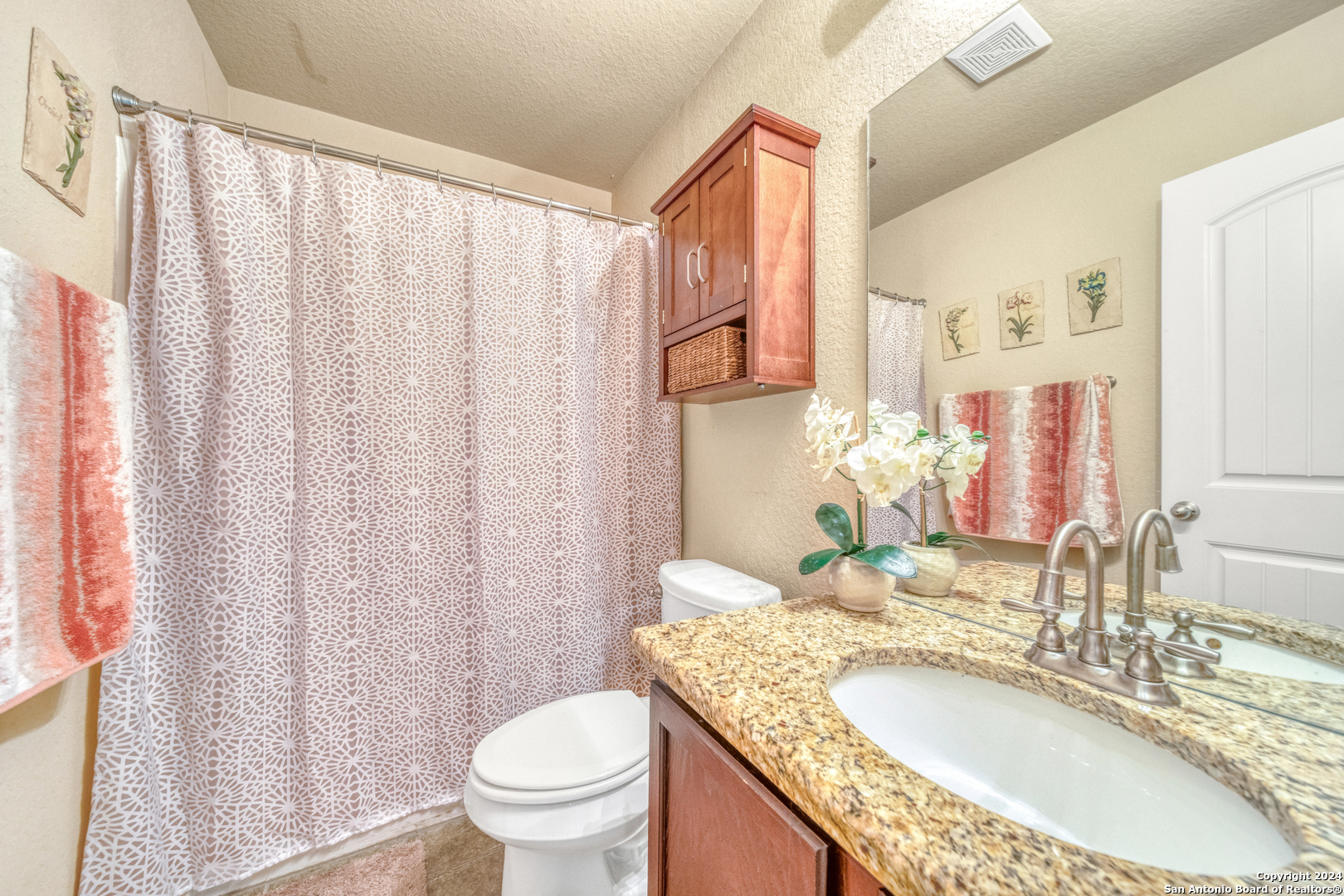 511 Fort Apache San Antonio, TX 78245 - Photo 22 of 32 a bathroom with a granite countertop sink and a mirror