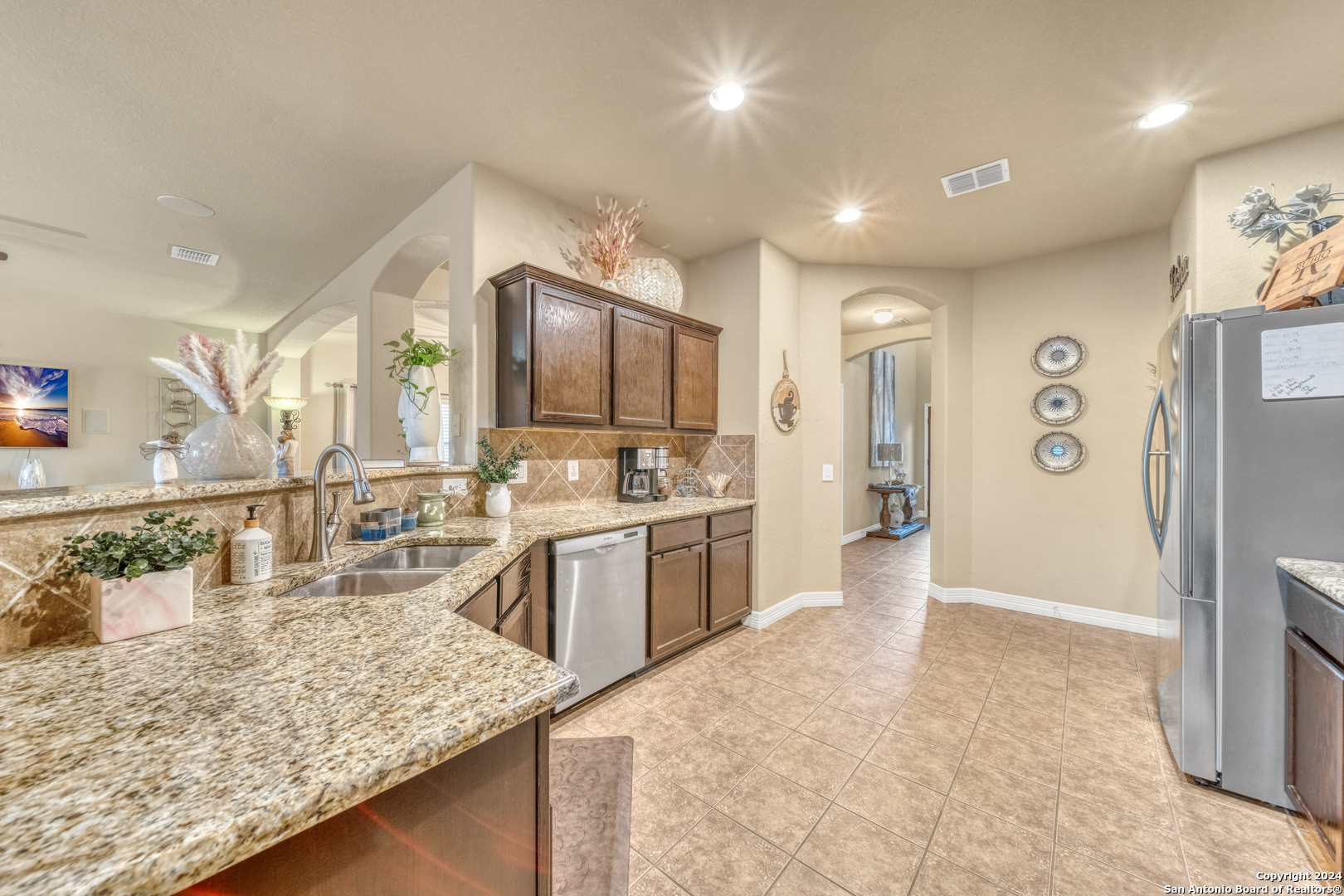 511 Fort Apache San Antonio, TX 78245 - Photo 10 of 32 a large kitchen with kitchen island a sink stove and refrigerator