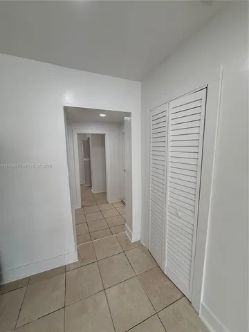 a view of a livingroom with an empty space and a window