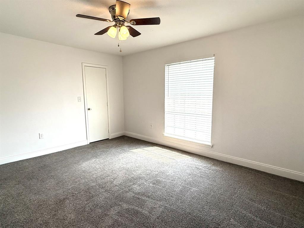 3650 Rickshaw Drive, Unit 3656 Dallas, TX 75229 - Photo 12 of 20 Carpeted empty room with baseboards and ceiling fan