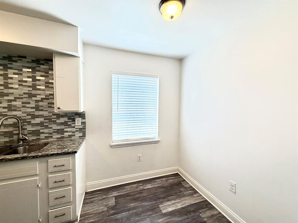3650 Rickshaw Drive, Unit 3656 Dallas, TX 75229 - Photo 5 of 20 Unfurnished dining area featuring dark wood-style floors and baseboards