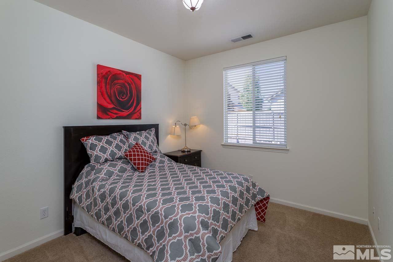 7150 Provence Circle Reno, NV 89523 - Photo 12 of 21 a bedroom with a bed and a window