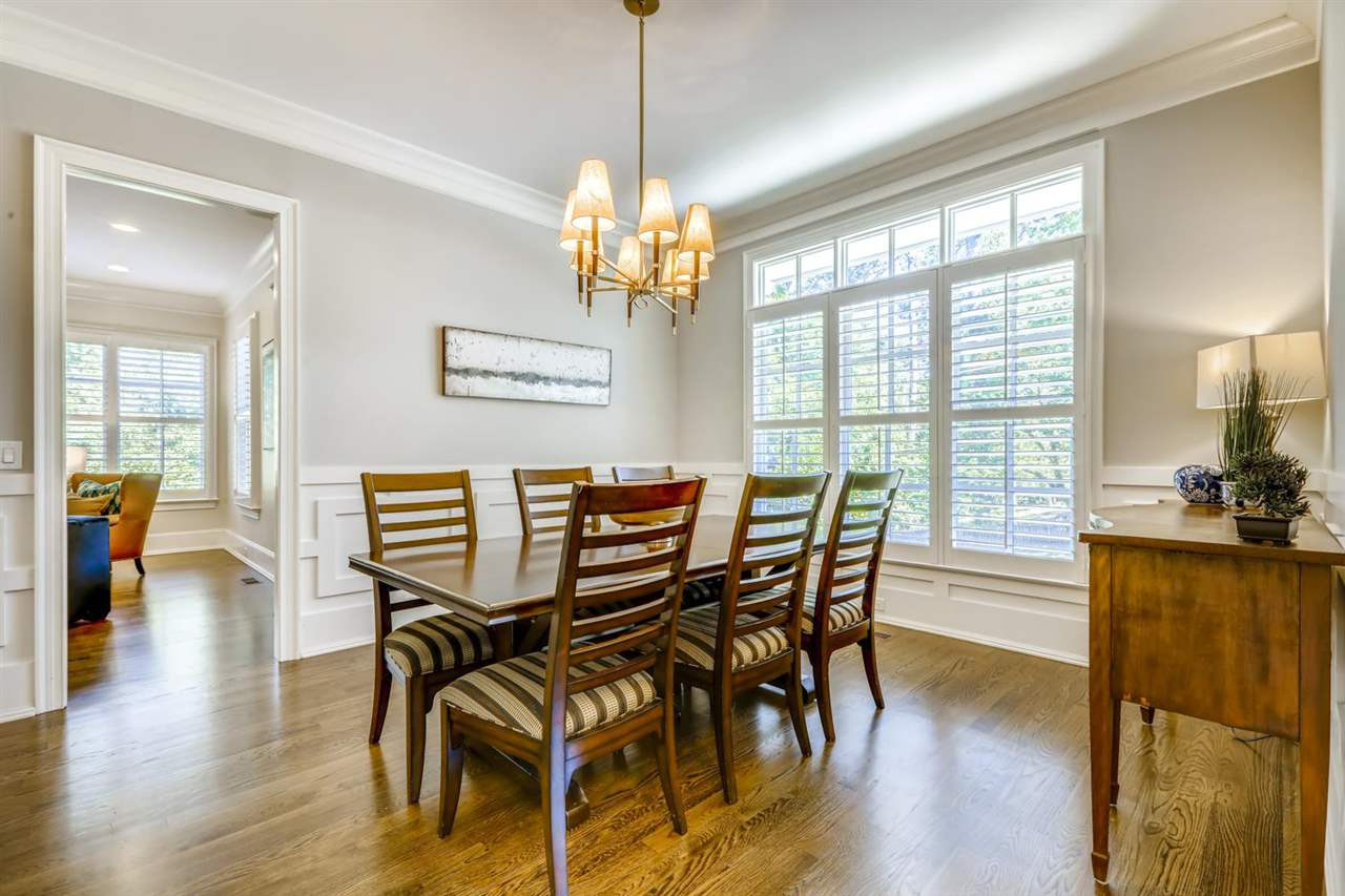 2827 Lewis Farm Road Raleigh, NC 27607 - Photo 4 of 30 Intricate Woodwork Below the Chair Rail, a Wall of Windows, A Butler's Pantry with Wine Fridge, Room for a Huge Table, and that Chandelier Make this Dining Room Extra Special. Dining Room