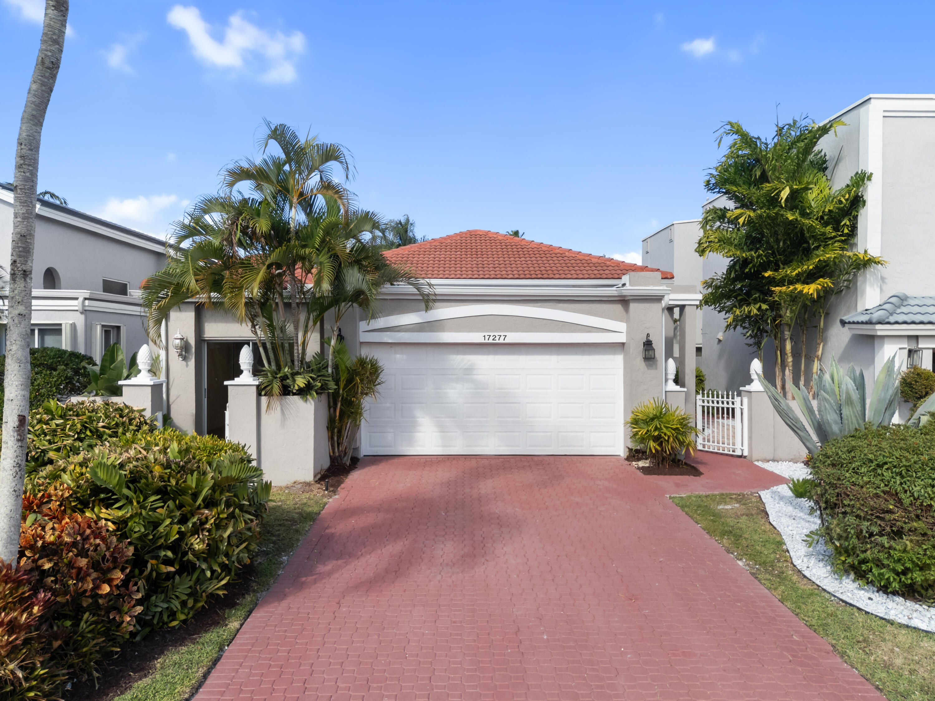 a front view of a house with a yard and a garage