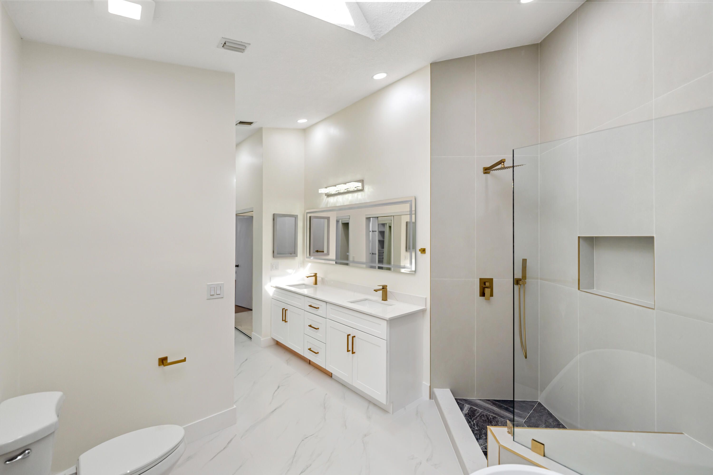 17277 Hampton Boulevard Boca Raton, FL 33496 - Photo 14 of 55 a bathroom with a double vanity sink toilet mirror and shower