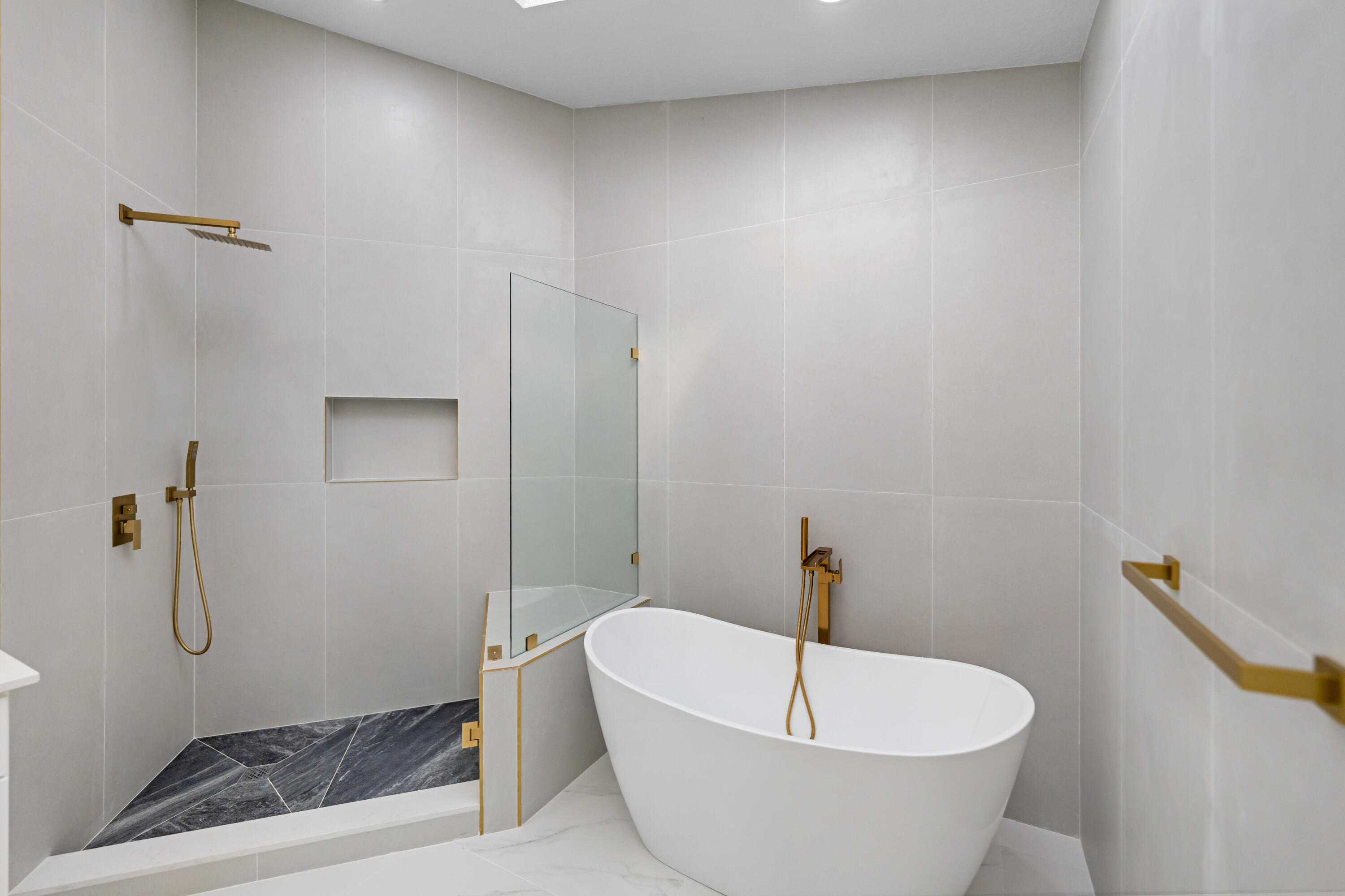 17277 Hampton Boulevard Boca Raton, FL 33496 - Photo 16 of 55 a bathroom with a white bath tub and shower