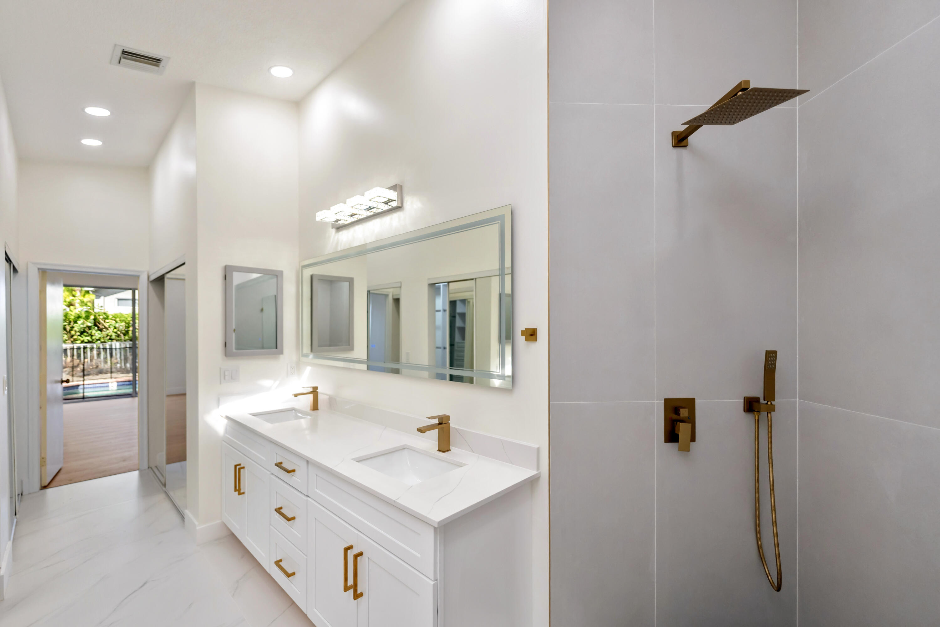 17277 Hampton Boulevard Boca Raton, FL 33496 - Photo 17 of 55 a bathroom with a double vanity sink a mirror and a shower