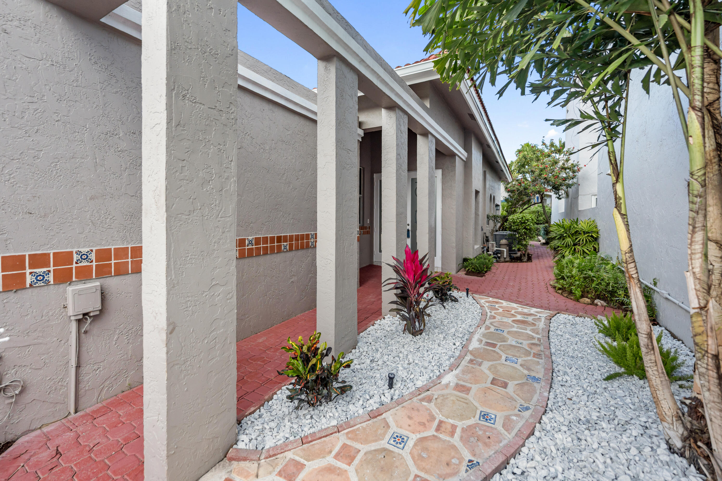 17277 Hampton Boulevard Boca Raton, FL 33496 - Photo 34 of 55 a front view of a house with a potted plant
