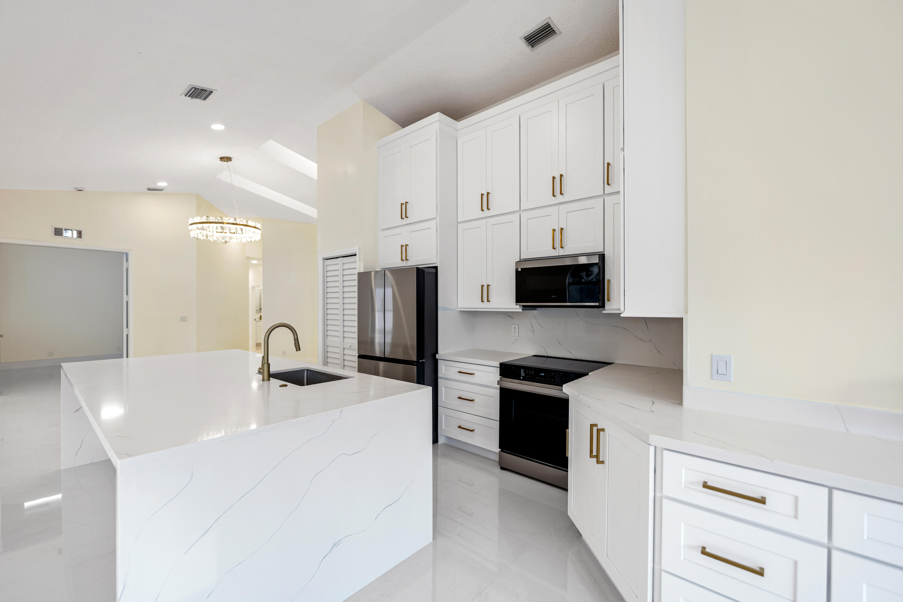 17277 Hampton Boulevard Boca Raton, FL 33496 - Photo 5 of 55 a kitchen with stainless steel appliances a sink a stove and a refrigerator