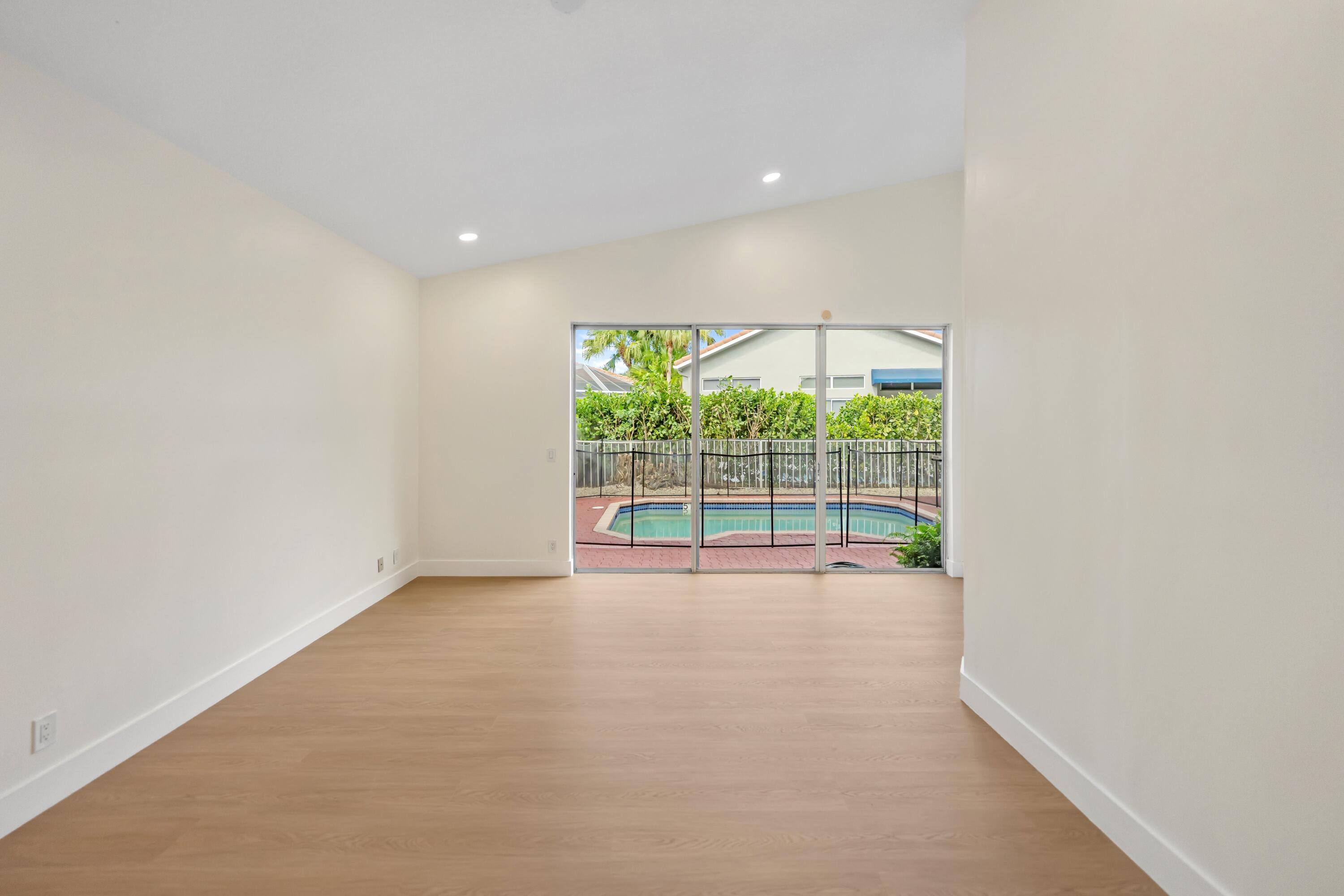 17277 Hampton Boulevard Boca Raton, FL 33496 - Photo 9 of 55 a view of an empty room with a sliding door