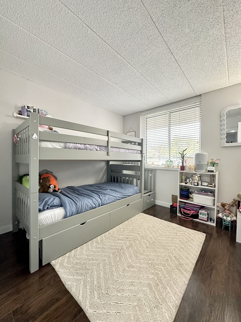 75 Kristin Circle, Unit 126 Schaumburg, IL 60195 - Photo 12 of 15 a bedroom with a bed and wooden floor