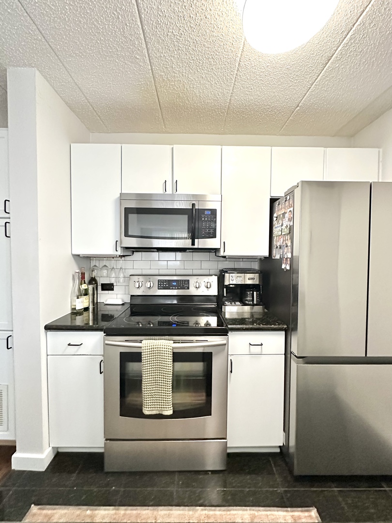 75 Kristin Circle, Unit 126 Schaumburg, IL 60195 - Photo 7 of 15 a kitchen with stainless steel appliances white cabinets and white appliances