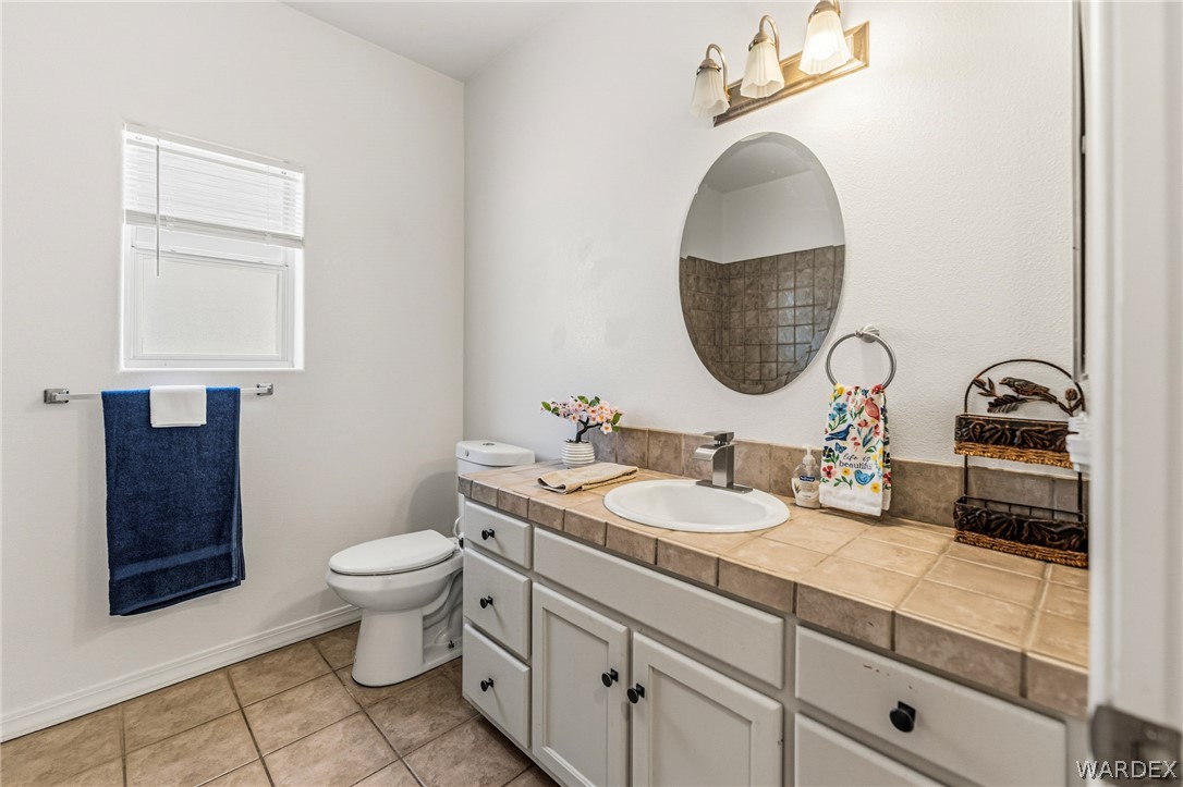 9332 Branded Road Kingman, AZ 86401 - Photo 26 of 44 a bathroom with a toilet sink and mirror