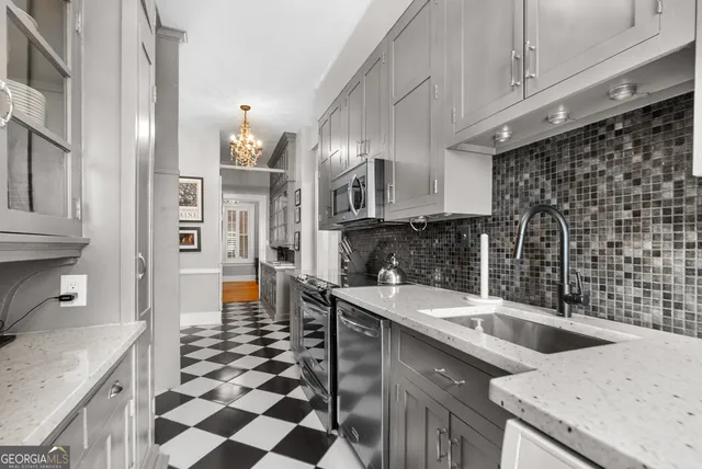 a kitchen with a sink a stove and cabinets