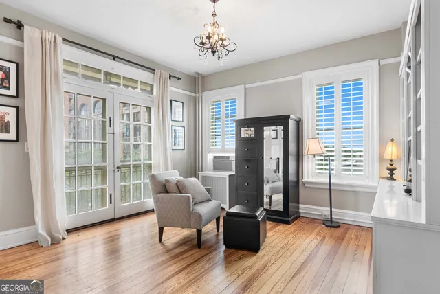 a view of a livingroom with furniture wooden floor and windows